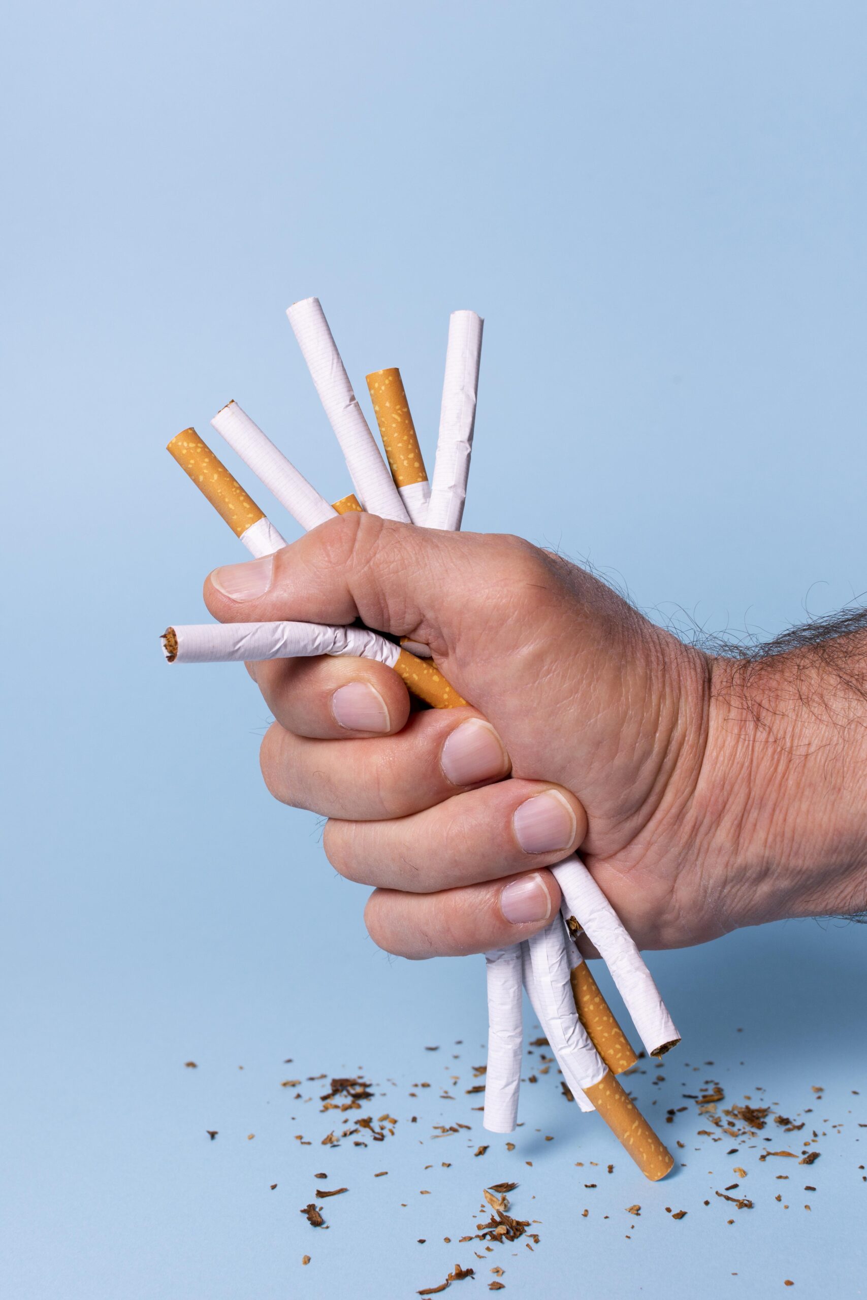 close-up-hand-holding-cigarettes
